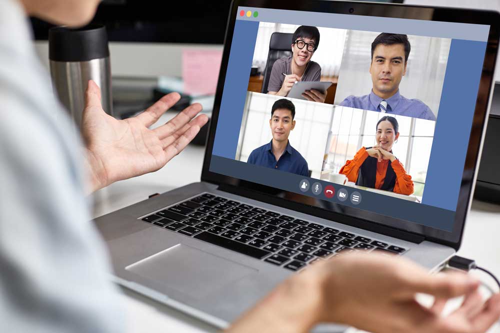 A man talking to his colleagues in an online meeting similar to Microsoft Teams