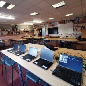 Laptops being prepared in a classroom at Lacon Childe School