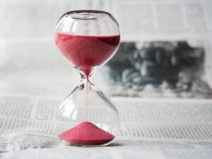 A photo of an hourglass with red sand